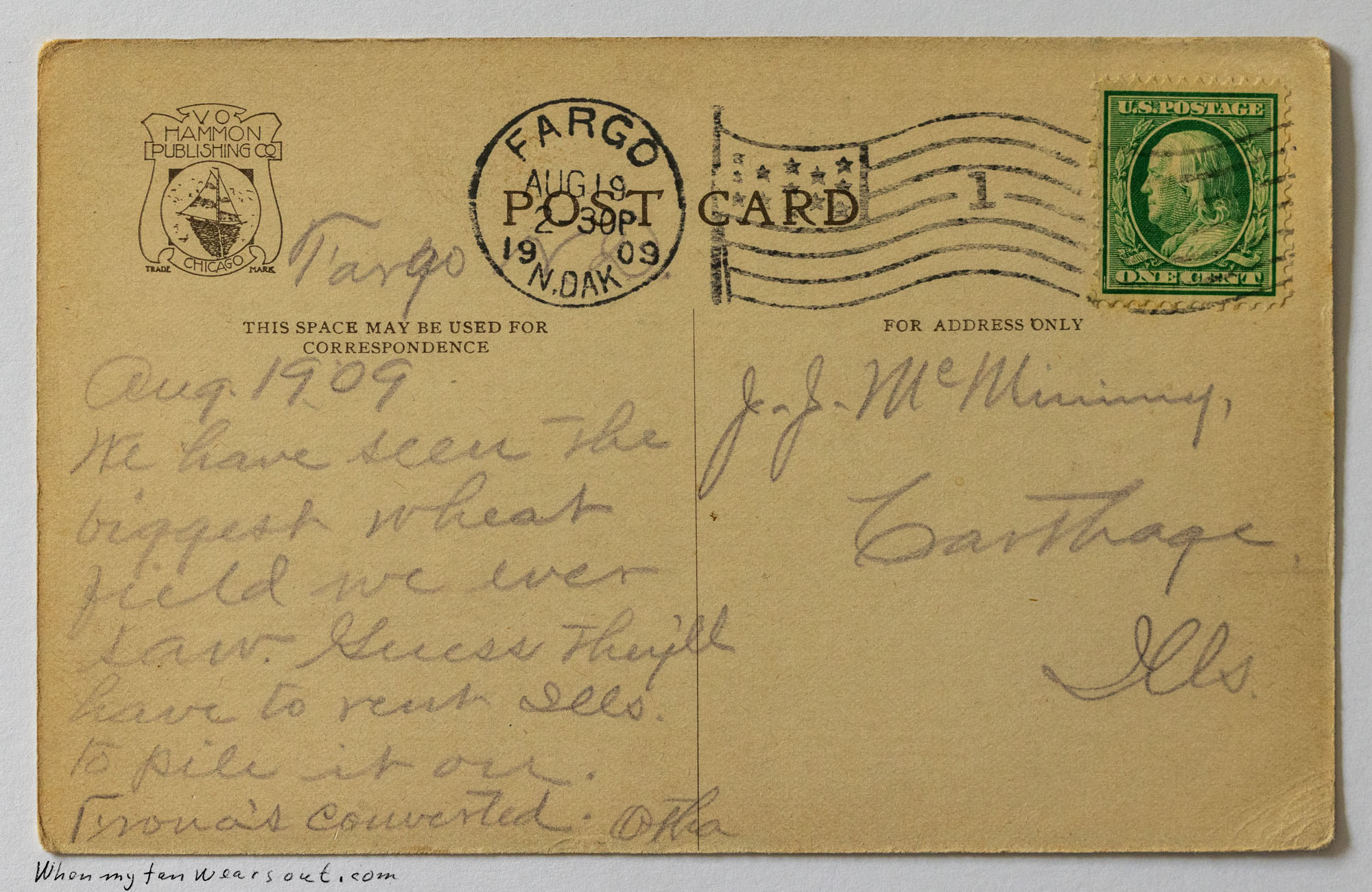 The back of the postcard features a Fargo, North Dakota postmark from August 19, 1909, a green one-cent Benjamin Franklin stamp, and a handwritten message about seeing a large wheat field and
