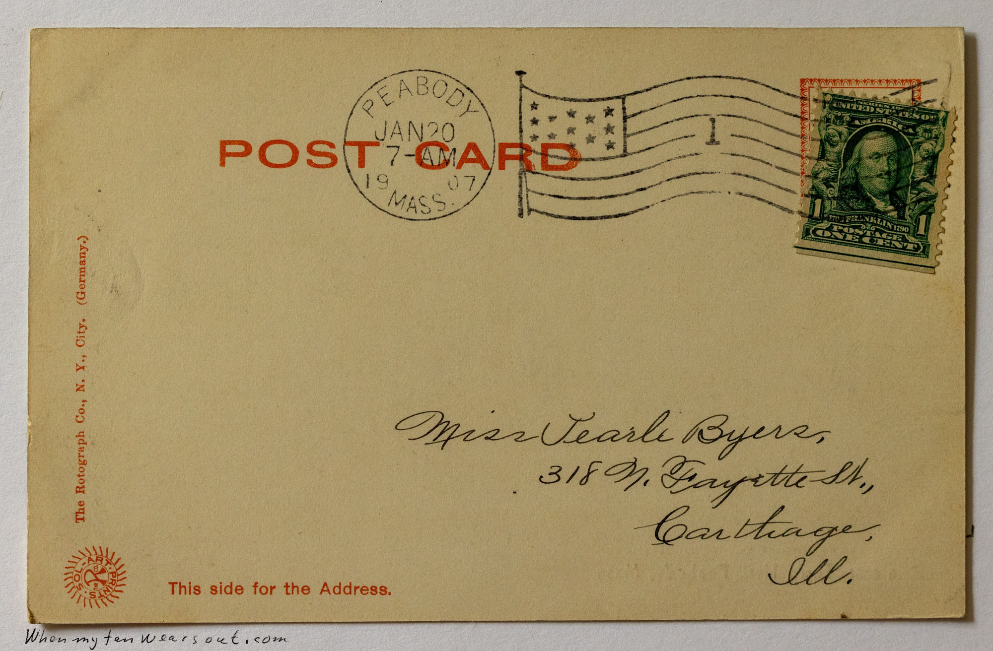 The reverse side of a vintage postcard with a light tan background. It features a green one-cent Benjamin Franklin postage stamp, a circular