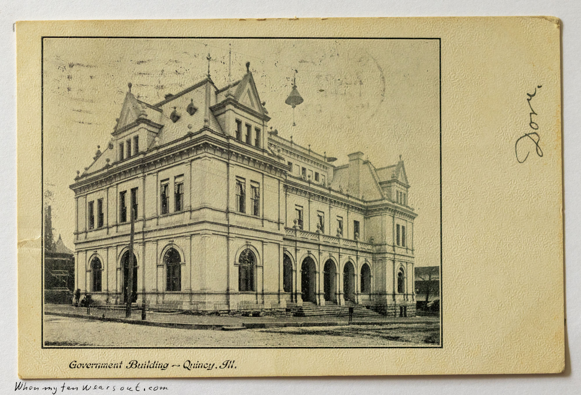 Front of postcard #0063: Black and white illustration of the stone Government Building in Quincy, Illinois, featuring prominent arched doorways o